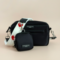 Black Cocopup London dog walking bag with white strap featuring red hearts and matching treat pouch.
