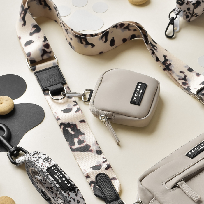 Ivory Tort dog walking bag bundle with black logo tags and animal print straps.