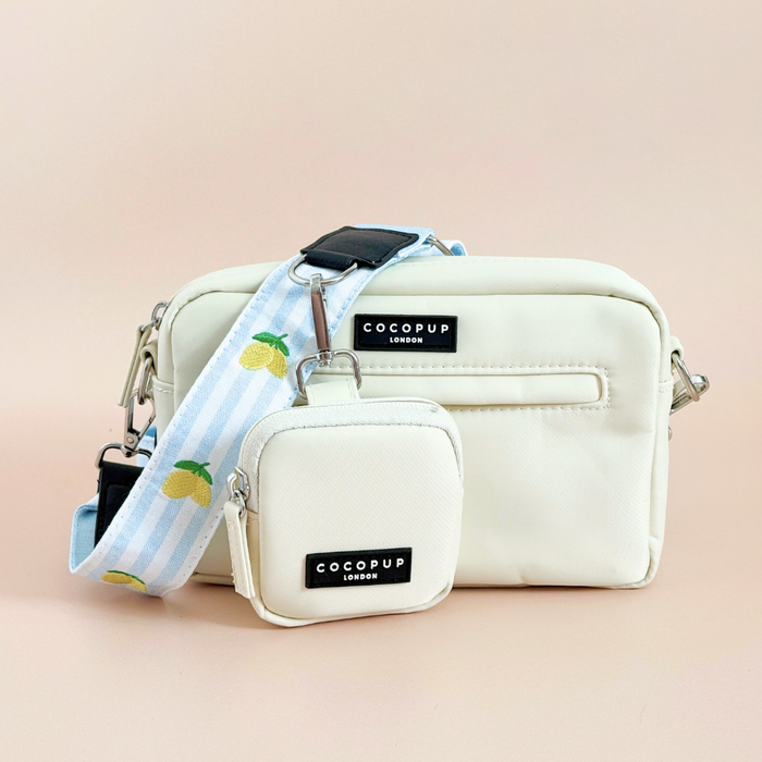 Cocopup London Dog Walking Bag Bundle in lemon print, blue lemon strap, and matching pouch on a light pink background.