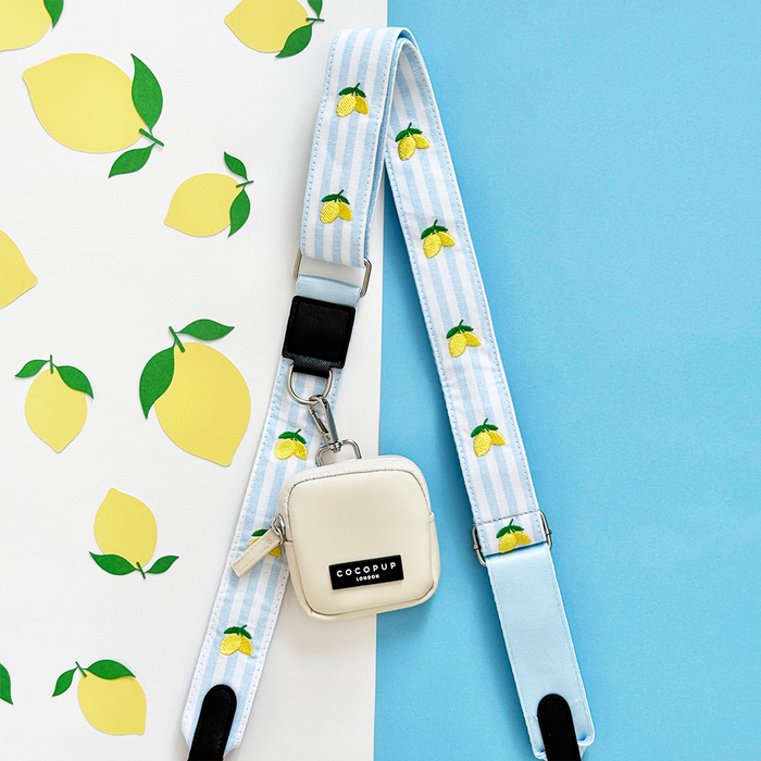 Cocopup London Dog Walking Bag Bundle in Living La Vida Lemon with lemon print and blue-striped strap on matching background.