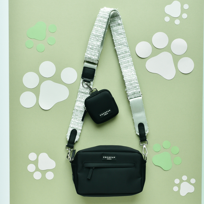 Matcha tweed dog walking bag by Cocopup London with a thick white strap, treat pouch, and matching poop bag dispenser.