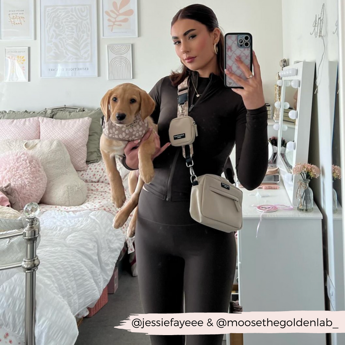 Woman in black takes mirror selfie with labrador puppy and a mocha floral Cocopup dog walking bag.