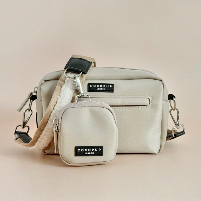 Two nude Cocopup London dog walking bags in small and medium sizes, each with a black label.