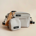 Cocopup London Pawtisserie dog walking bag and matching treat pouch in soft beige with subtle pattern on neutral backdrop.