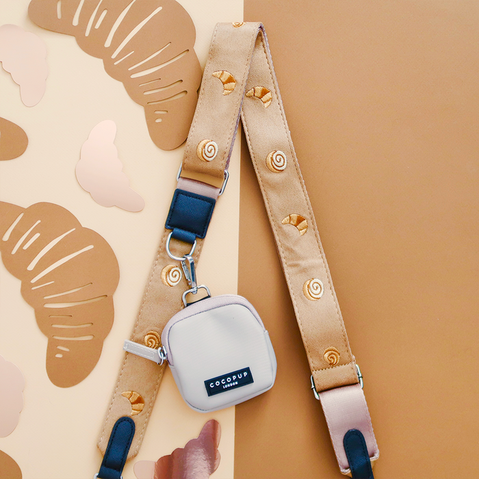 Tan bag strap with croissant pattern and cut-outs, part of Cocopup Londons Pawtisserie Dog Walking Bag Bundle.