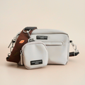 Two Cocopup London dog walking bags, brown with leaf-patterned detachable straps and black labels.