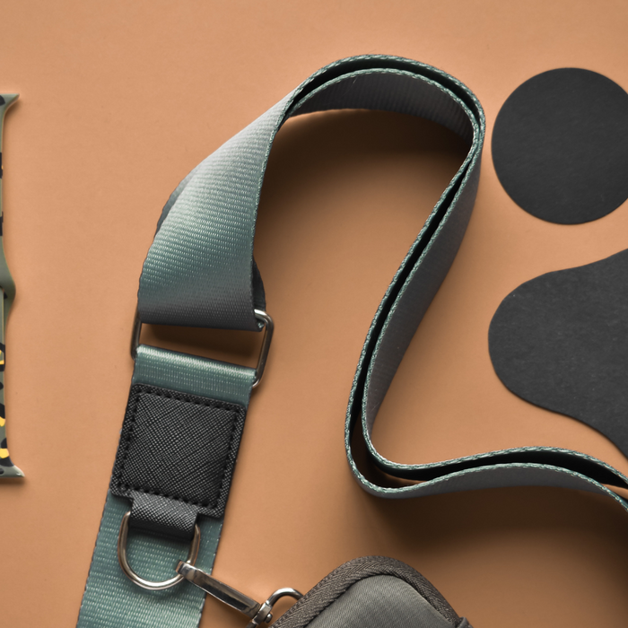 Khaki Cocopup London dog walking bag with a camo strap, gray strap, and two black accents.