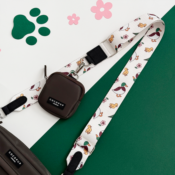 Dog walking bag bundle with a duck print, detachable strap, and built-in poop bag dispenser.