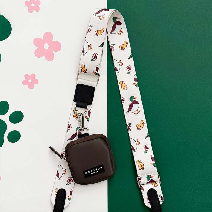 Brown square dog walking bag with duck and flower print, white strap; Cocopup London Puddle Pup bundle.