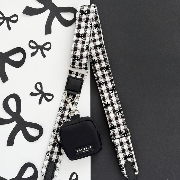 Black and white checkered dog walking bag with matching treat pouch and bow accents.