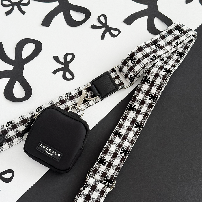 Cocopup London Pup in Paris dog walking bag with a black and white checkered strap on a patterned backdrop.