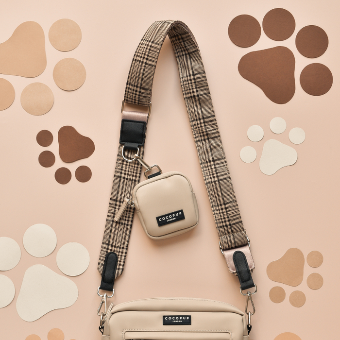 Beige dog walking bag set with plaid strap, matching treat pouch, and poop bag dispenser from Cocopup London.