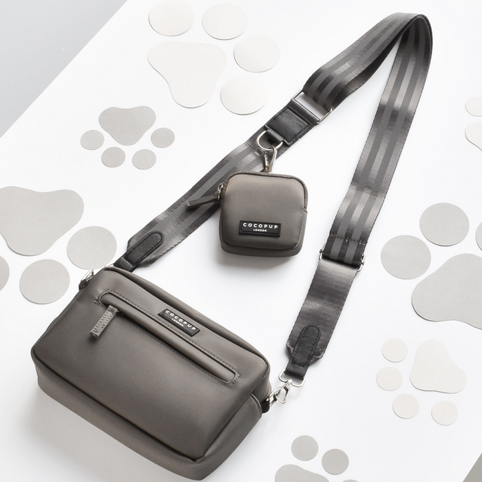 Reflective mocha dog walking bag with matching small treat pouch on a white background with grey paw prints.