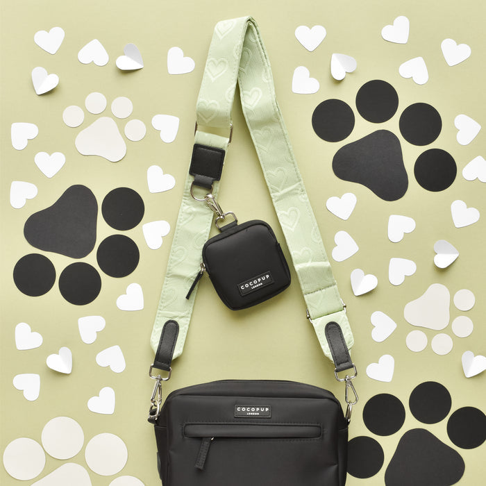 Sage green Cocopup London dog walking bag with heart pattern, matching treat pouch, and small case.