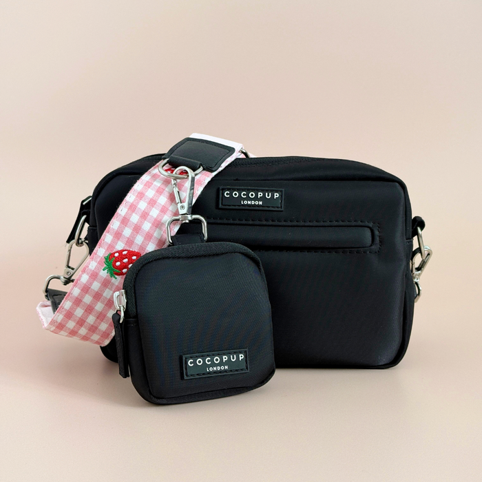 Strawberry-patterned Cocopup London dog walking bag with pink check strap, matching dispenser, and strawberry keychain.