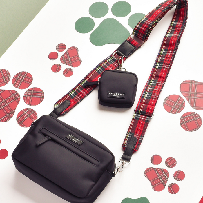 Tartan Cocopup London dog walking bag with matching treat pouch and poop bag dispenser on a paw-print background.