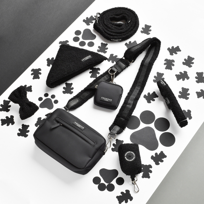 Teddy Baloo Cocopup London dog walking bag bundle with matching leash, harness, and bowtie on a paw print background.