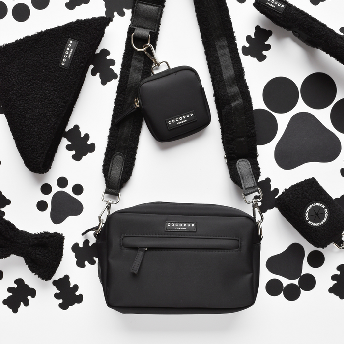 White dog walking bag bundle with paw print pattern, treat pouch, and poop bag dispenser by Cocopup London.
