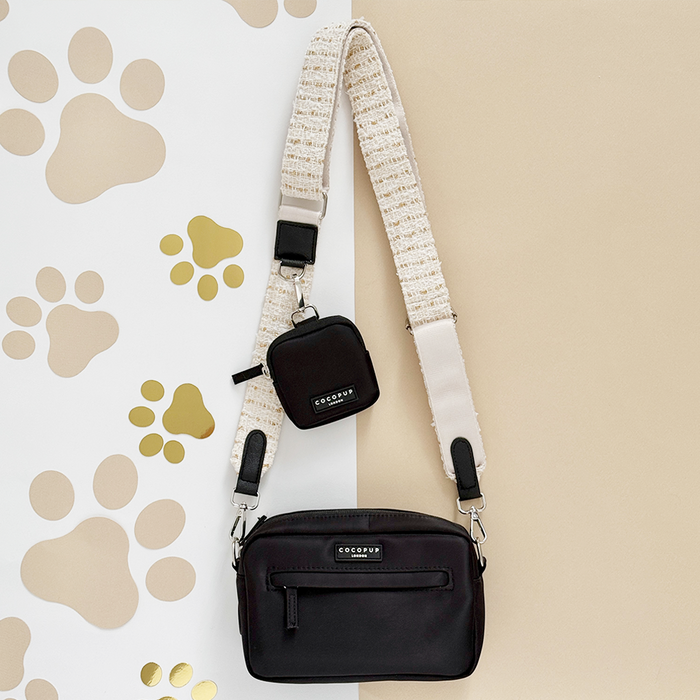 Vanilla textured tweed dog walking bag bundle with matching strap, pouch, and treat pouch on paw print background.