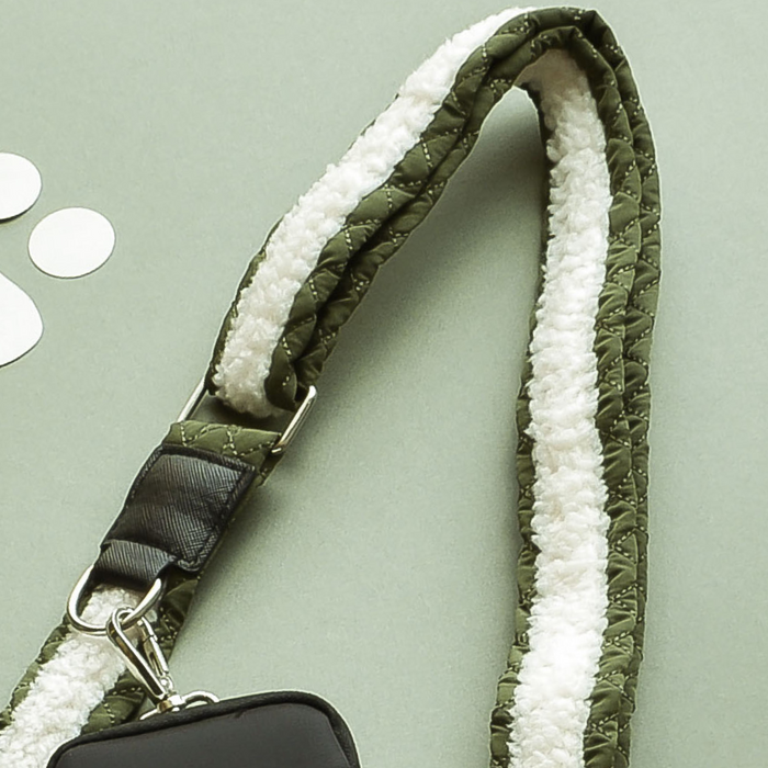 Khaki quilted dog walking strap with white fleece lining, shown on a pale green background.