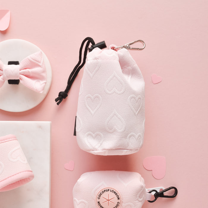 Baby pink heart-patterned drawstring treat pouch from Cocopup London on a pastel pink background.