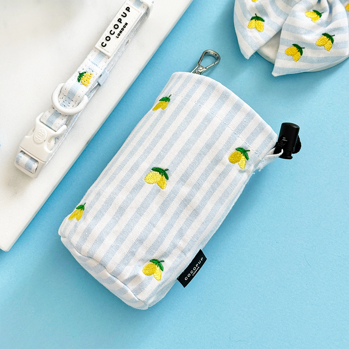 Light blue striped treat pouch with lemon prints, matching collar, and bowtie from Cocopup London.