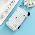 Light blue striped treat pouch with lemon prints, matching collar, and bowtie from Cocopup London.