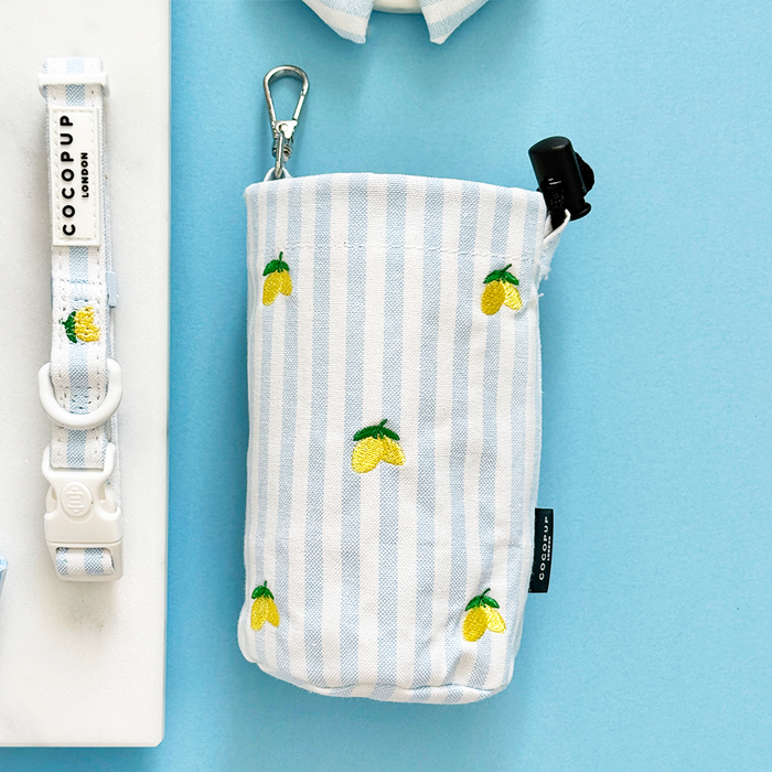 Yellow lemon-print treat pouch with matching collar, both on a light blue background.