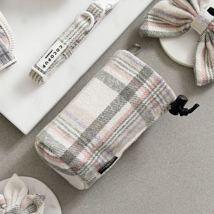 Oxford plaid drawstring treat pouch, matching bow ties, and collar with tag on a light grey background.