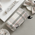 Oxford plaid drawstring treat pouch, matching bow ties, and collar with tag on a light grey background.