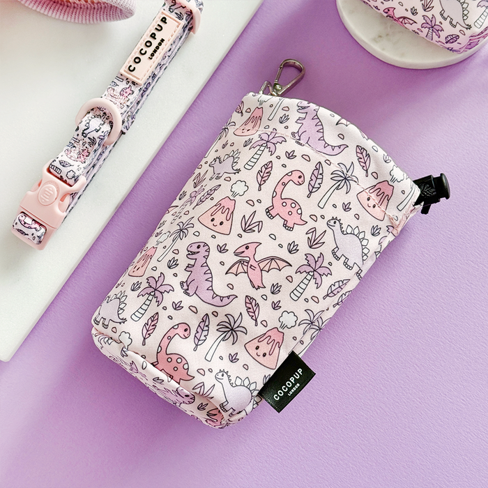 Lavender drawstring treat pouch with pink and purple dinosaur pattern, Cocopup London branding.