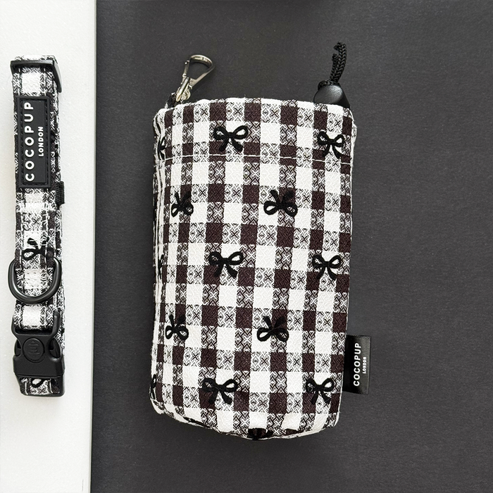 Black and white plaid drawstring treat pouch with matching collar featuring bows, both by Cocopup London.