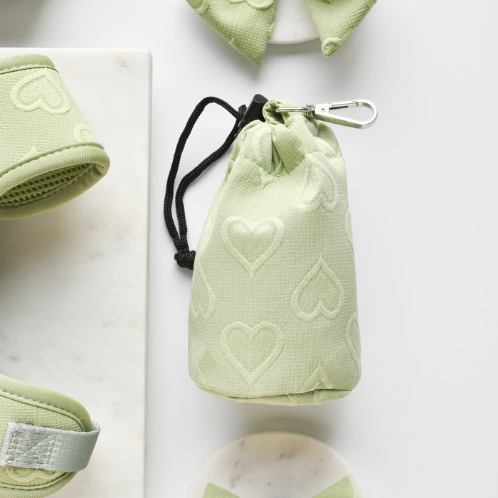Sage green Cocopup London drawstring treat pouch with heart pattern and a sturdy fabric finish.