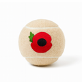 Beige dog tennis ball with a red poppy flower embroidered on one side.