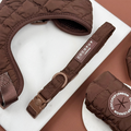 Espresso brown quilted dog collar with safety lock, shown on a white marble surface.
