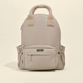 Caramel Latte Cocopup London rucksack with fuzzy handles and several pockets.