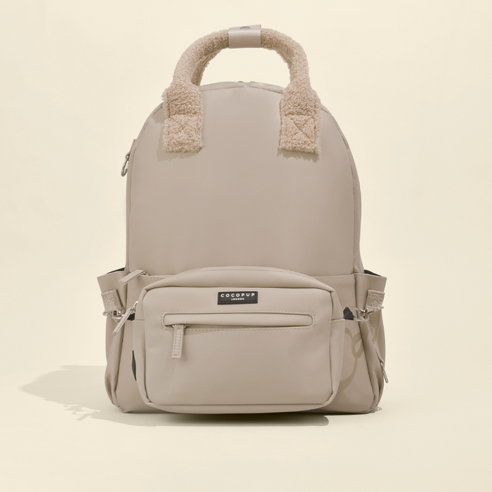 Caramel Latte Cocopup London rucksack with fuzzy handles and several pockets.