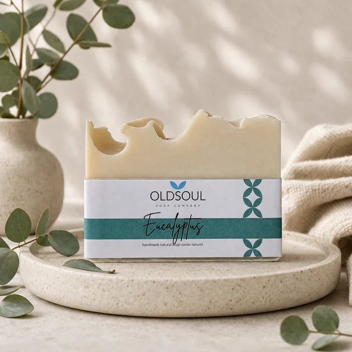 Bar of soap with 'Oldsoul' label on a stone surface with greenery