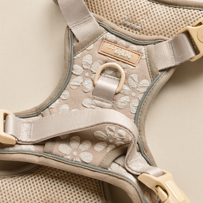 Mocha brown dog harness with floral pattern, mesh lining, adjustable straps, and a metal leash ring.