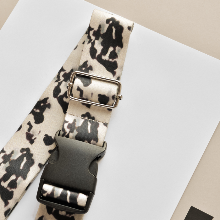 Ivory tortoiseshell-patterned bum bag strap with black buckle and silver slider by Cocopup London.