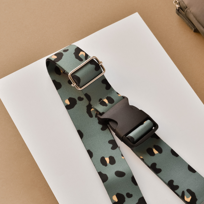Khaki leopard print bum bag strap with green and black pattern and a black buckle.