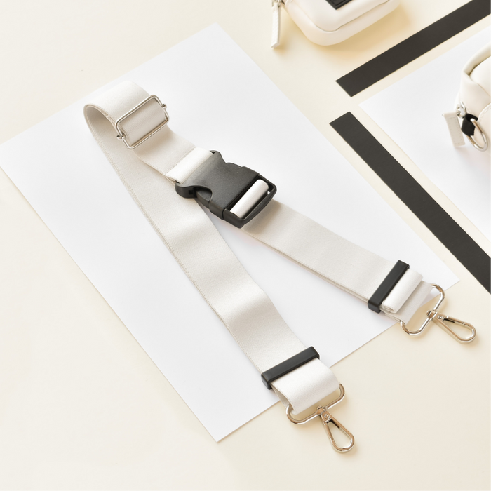 Oyster white bum bag strap with silver clips and a black buckle, by Cocopup London.