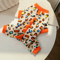 Orange leopard print fleece pet suit with orange ribbed trim
