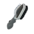 FURminator Dual Grooming Brush showing the metal bristle side