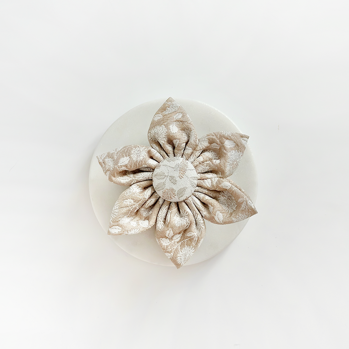 Beige fabric collar flower with patterned petals by Cocopup London, displayed on a white background.