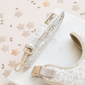 Floral Cocopup London harness and lead set with gold hardware on a marble surface.