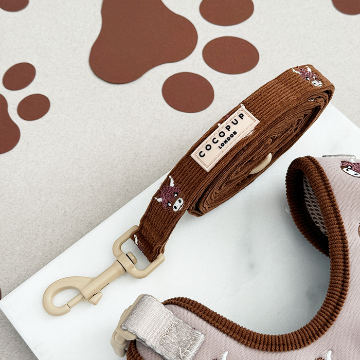 Cow-patterned dog leash by Cocopup London with brown and white spots and metal clasp.