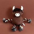 Brown corduroy dog toy shaped like a highland cow, with rope limbs, white horns, and snout.