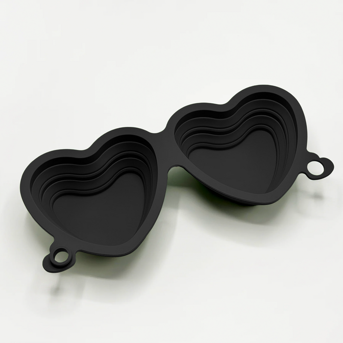 Black heart-shaped collapsible bowls from Cocopup London, nested together on a white background.