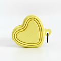 Butter yellow heart-shaped collapsible pet bowl with a carabiner, by Cocopup London.